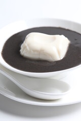 chef cook thick black sesame sweet soup with soya milk pudding jelly in white bowl Chinese traditional dessert menu