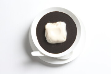 Fototapeta na wymiar chef cook thick black sesame sweet soup with soya milk pudding jelly in white bowl Chinese traditional dessert menu