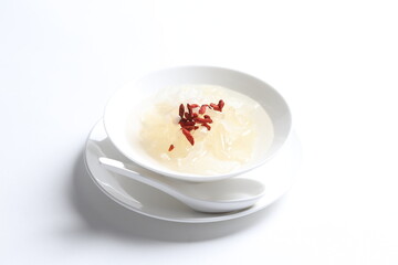chilled double boiled fresh bird nest with hashima and wolf berries asian sweet soup in white bowl...