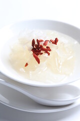 chilled double boiled fresh bird nest with hashima and wolf berries asian sweet soup in white bowl healthy dessert menu
