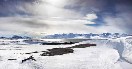 Panoramic view of the mountains, snow and fjords of Svalbard