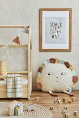 Creative composition of cozy scandinavian child's room interior with mock up poster frame, plush...