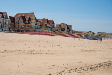 Yellow sandy beach in small Belgian town De Haan or Le Coq sur mer, luxury vacation destination, summer holidays