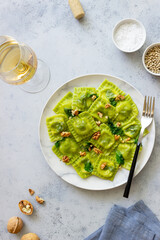 Green ravioli with ricotta cheese, spinach and nuts. Healthy eating. Vegetarian food. Italian cuisine.