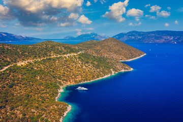 Naklejka premium White sail boat isolated in blue sea water. Sailboat in the sea in the sunlight, luxury summer adventure, active vacation in Mediterranean sea. Yacht sailing on opened sea. Sailing boat.