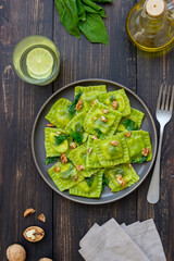 Green ravioli with ricotta cheese, spinach and nuts. Healthy eating. Vegetarian food. Italian cuisine.