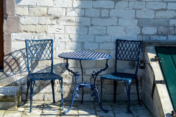 Fototapeta na wymiar Vintage metal bistro table and chairs set in outdoor cafe