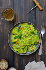 Green ravioli with ricotta cheese, spinach and nuts. Healthy eating. Vegetarian food. Italian cuisine.
