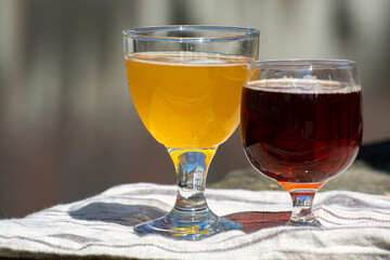 Tasting of Belgian beer on open cafe or bistro terrace with view on medieval houses and canals in Bruges, Belgium