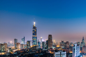 Fototapeta na wymiar Night view of Zifeng Building and city skyline in Nanjing, Jiangsu, China