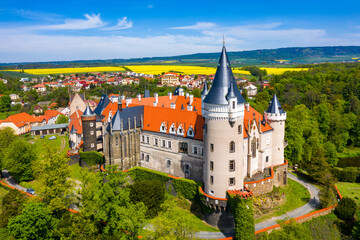 Fototapeta na wymiar Aerial view of Zleby castle in Central Bohemian region, Czech Republic. The original Zleby castle was rebuilt in Neo-Gothic style of the chateau. Chateau Zleby, Czechia.