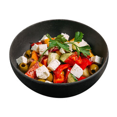 Isolated black bowl of fresh greek salad with vegetables and cheese