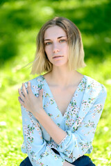 Outdoors portrait of beautiful young woman with green eyes.