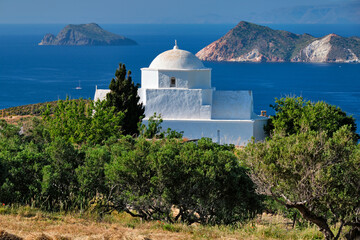 View of Milos island and Greek Orthodox traditional whitewashed church in Greece