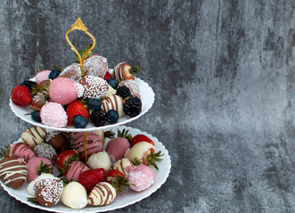 Variety of chocolate strawberries group of strawberries in chocolate on white plate and gray background, a dessert for Valentine's Day, a romantic, food gift.