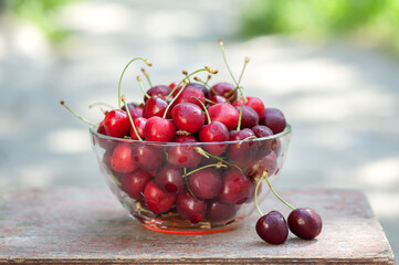 Ripe red cherries in a cup. Summer background 