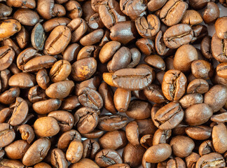Roasted coffee beans on a wooden background.