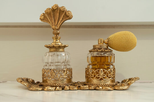 Vintage golden perfume bottles in the bathroom
