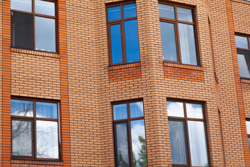 The facade of a new modern residential building with glazing.