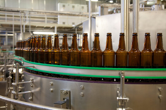 Beer bottling plant, rows of bottles, automated process