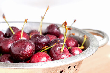 Washed fresh ripe sweet cherries in metalic bowl summer healthy food