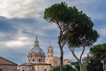Fototapeta na wymiar A view of Santi Luca e Martina church with clock tower of Capitoline museum in background