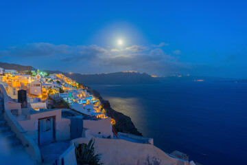 Greece Santorini island in Cyclades, wide view of white washed colorful houses at night