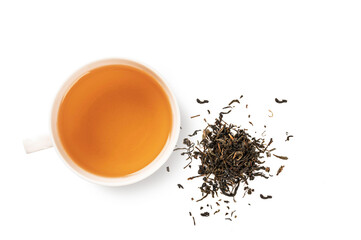 Black tea in glass cup with dry tea leaves isolated. Top view
