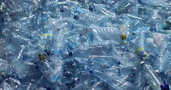 A lot of plastic blue bottles with caps. Close-up. Storage, reuse and recycling. Environmental protection concept.