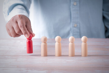 Leadership business concept, hand holding leader to success, teamwork business leadership, hand holding wooden figures leader create business idea conceptual.