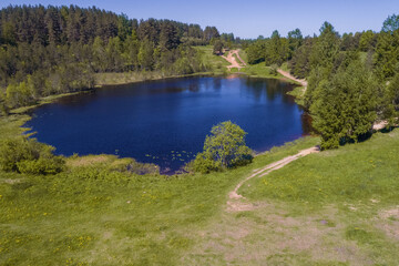 Fototapeta na wymiar View of the Third Tokkarevskoye Lake on a sunny May day. Leningrad region, Russia