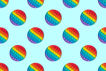 Round colored Pop it toy seamless pattern. New popular silicone anistress toys on blue background. Minimalistic top view