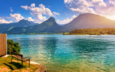 Fototapeta premium Embankment promenade at the Wolfgangsee lake in Austria. Wolfgangsee is one of the best known lakes in the Salzkammergut resort region of Austria. Village St Wolfgang on the lake Wolfgangsee, Austria