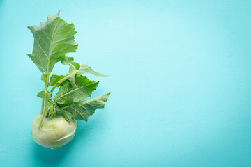 Fresh kohlrabi on green color background with copy space, Organic vegetables