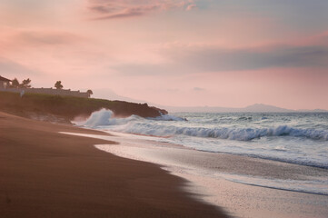 house villa on yje cost brutal waves romantically crash on terracotta rocks at sunset on a Caribbean island on the coast of the Atlantic Ocean