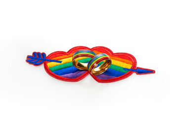 Love wins concept with a multicolored heart and wedding rings. Equality and love protection