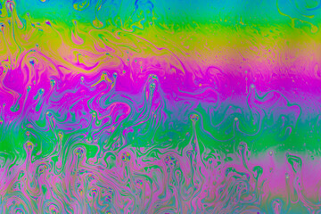 Fototapeta na wymiar Fluid soap bubble psychedelic colorful abstract art. Surreal patterns with rainbows and waves of color in motion.