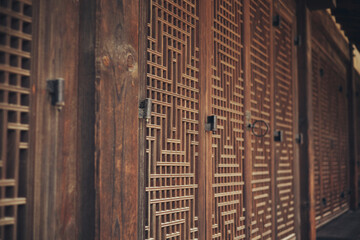 A door made of grid-patterned wood made of traditional Korean style in an old palace