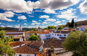 Fototapeta na wymiar Historic walled town of Obidos, near Lisbon, Portugal. Beautiful streets of Obidos Medieval Town, Portugal. Street view of medieval fortress in Obidos. Portugal.