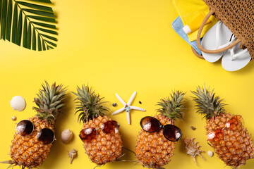 Summer fruit background design concept. Beach with shells, pineapple and palm leaves on yellow...