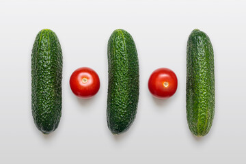 Ripe cucumbers and tomatoes, isolated on a white background