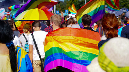 LGBT equality march, pride parade. Fight for LGBTQ+ rights. Rainbow flags, banners and masks. Struggle for LGBT rights during coronavirus pandemic.     - obrazy, fototapety, plakaty