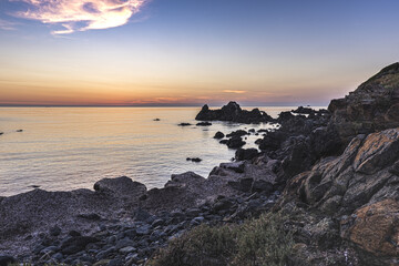 Rocky coastline at the famous Sanguinaires islands near corsican Ajaccio city under beautiful sunset light.