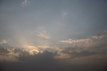 Naklejka na ściany i meble Beautiful cloudy sky - shining clouds, behind which the sun has hidden