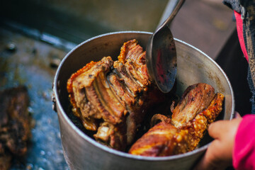 cooking a pork on the grill with a lot of fat