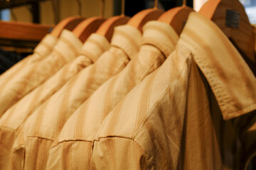 Fototapeta na wymiar Male white cotton shirts on hangers close-up in store. Male retail fashion. 