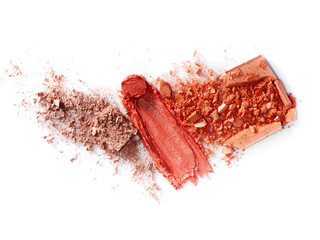 On a white background are broken blush for the face or eye shadow and smeared pink lipstick. A palette of shades. Cosmetic swatches. Decorative cosmetics on a white background. Eye makeup product.