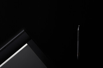 Electronic drawing pen tablet with pen stylus isolated on black background. Copy space. Banner. Empty place for text. Graphic designer tool. Retoucher workplace concept. Equipment for creative artist