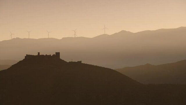 Wind turbines power generator farm for renewable energy production in mountains, Tabernas desert, Andalusia Spain. Alternative green clean energy, ecology