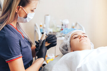woman prepare instruments for permanent makeup to work use wrap film tape for sterility, tools for tattoo ready to use
